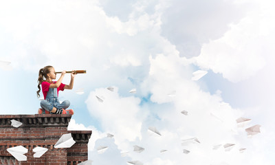 Concept of careless happy childhood with girl exploring this world