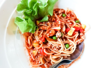 Spaghetti with tomato sauce, chicken in white cup in restaurant steak.