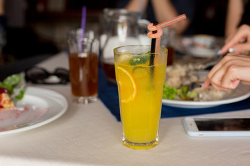 lunch. glass of lemonade with lemon on the table.