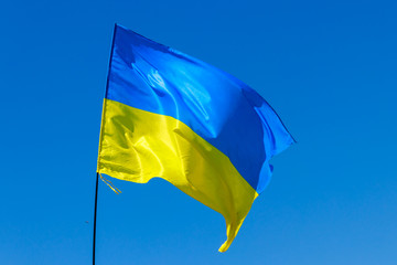 Blue-yellow flag of Ukraine on blue sky background