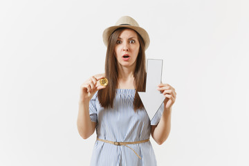 Young shocked sad woman holding bitcoin, coin of golden color, down value fall arrow isolated on white background. Finance and business, online virtual currency concept. Advertising area. Copy space.