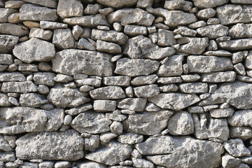 part of old dry stone wall built without cement or grout in southern france