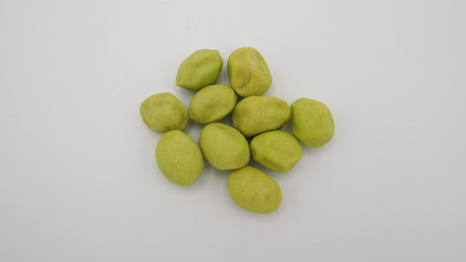 Green snack pistachios on white background.