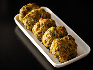 chicken chop cutlet baked in an oven on a white plate and a black background