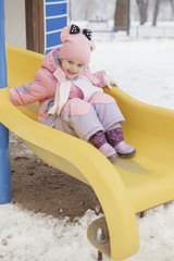 Happy loving caucasian family of mother father and daughter play, having fun in winter snowy park. Cute little girl playing