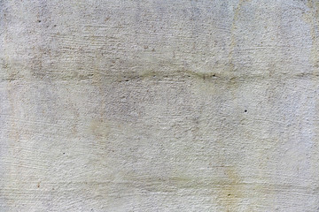Uneven concrete wall painted in different colors as a background
