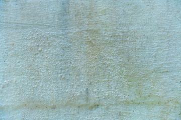 Uneven concrete wall painted in different colors as a background