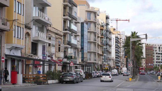 Street traffic and buildings on the embankment line of Malta city Gzira