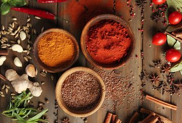 Various spices on wooden background