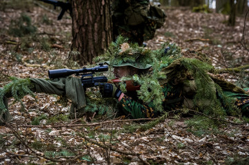 Airsoft player during patrol in forest