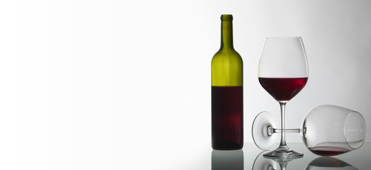 Bottle and glasses of red wine .