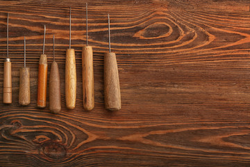 Craft tools for work with leather on wooden table