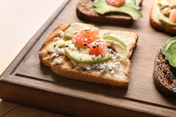 Tasty toasts on wooden board