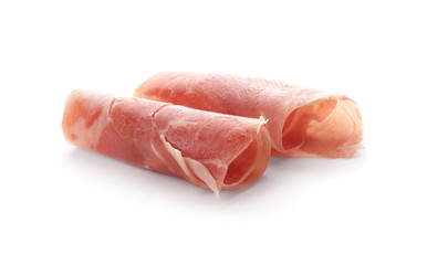Tasty prosciutto slices on white background