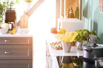 Modern furniture with kitchenware and products indoors