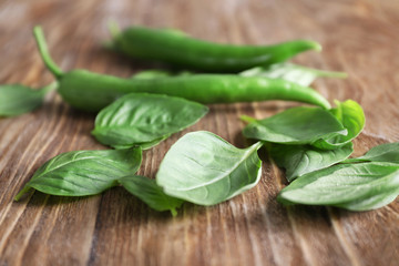 Fresh basil leaves on wooden background, closeup