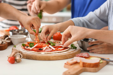 Friends cooking together in kitchen