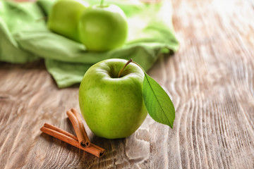 Fresh apple and cinnamon on wooden background