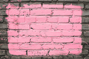 Old realistic dirty brick wall made of pink brick. Uneven brickwork. Center of wall is painted...