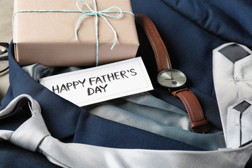 Composition with gift box, male clothes and accessories on table. Happy Father's Day celebration