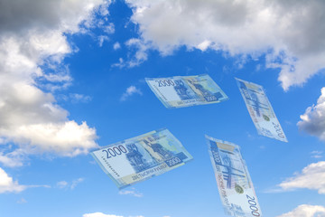 Sky Collage. Mirage - against the blue sky flying transparent Russian rubles. New banknote 2000 rubles