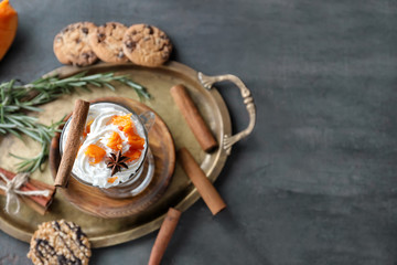 Tray with fresh latte in glass on table