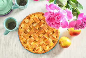 Composition with delicious apple pie on wooden background