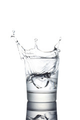 water glass with ice cube splashing in, copy space and clipping path included