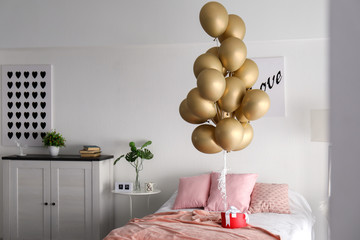 Bedroom interior with gift box and air balloons