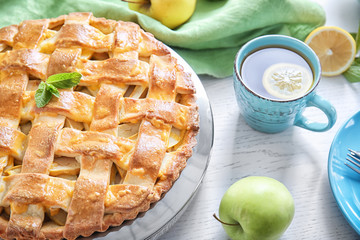 Plate with delicious apple pie on table, closeup
