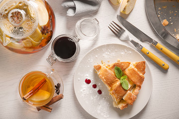 Composition with piece of delicious apple pie on table