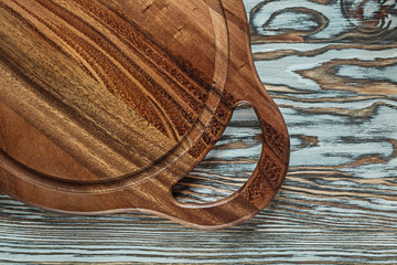 Round chopping board on wooden surface