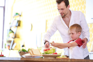 Image of man and son preparing salad