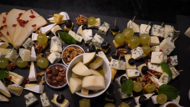 Catering food layout - fruit and cheese snacks are laid out on the table for guests on party