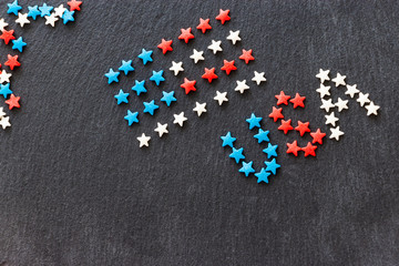 American flag and word USA concept 4th July Independence Day. Slate background. Flat lay. Top view. Copy space. Selective focus.