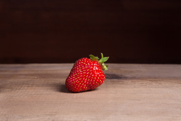 Strawberry fresh ripe sweet berry on wooden background.