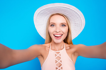 Self portrait of cheerful positive lady in pink outfit shooting selfie on front camera with two...