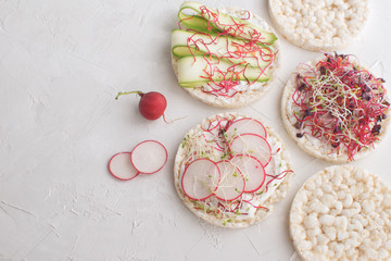 Healthy snack concept Rice bread Crispy bred Radish slices Sprouts Marrow slices Cottage cheese...