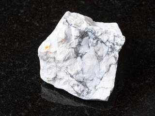 rough Howlite stone on black granite
