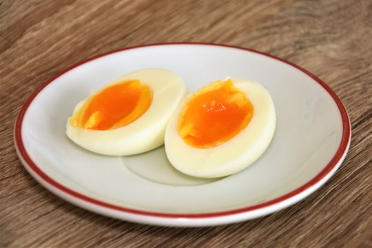 halved boiled egg on a white saucer