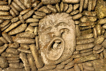 Ancient stone face yawns background 