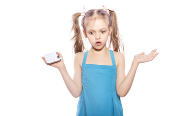 Naklejka premium Young seven years old brunette girl in blue dress on a white isolated background. Amazement, surprise emotions on her face. Talking on the phone