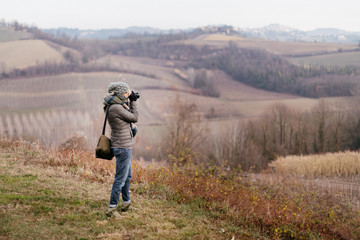Fototapeta na wymiar Woman taking pictures in the countryside