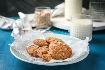 Plate with delicious oatmeal cookies on table