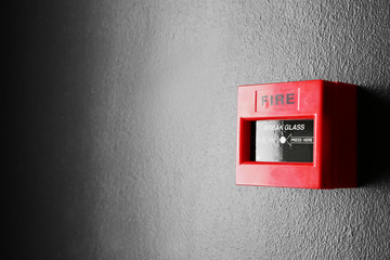 Modern fire call point on wall indoors