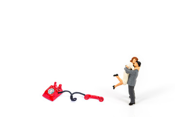 selective focus of miniature couple with phone and board isolated on white , Image for business idea concept