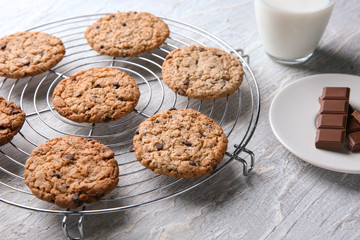 Delicious oatmeal cookies on textured background