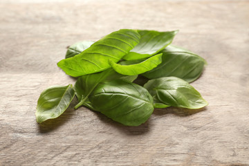 Fresh green basil leaves on wooden background