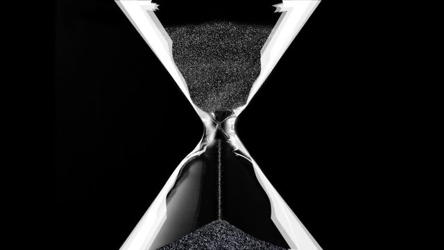 Hourglass closeup over black