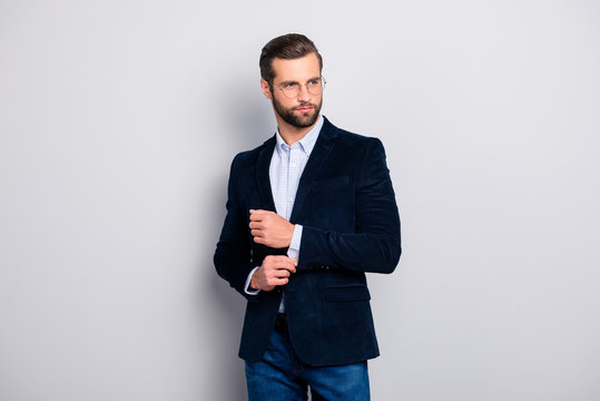 Portrait of elite elegant attractive dreamy fashionable groomed entrepreneur wearing dark blue velvet jacket checkered shirt correcting fixing cufflinks on sleeves isolated on gray background